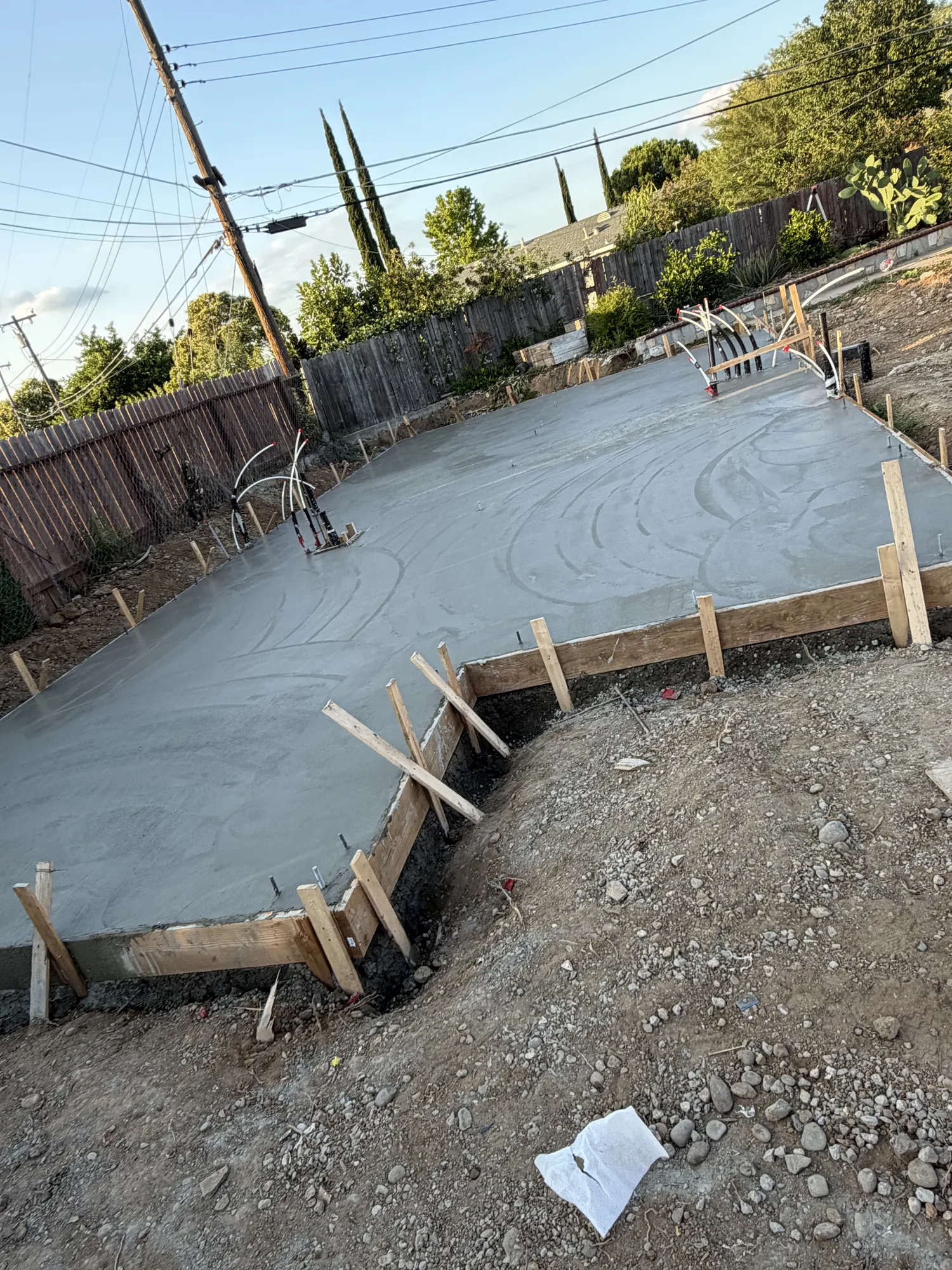 Poured ADU foundation slab with plumbing stub-ups set, ready for inspection