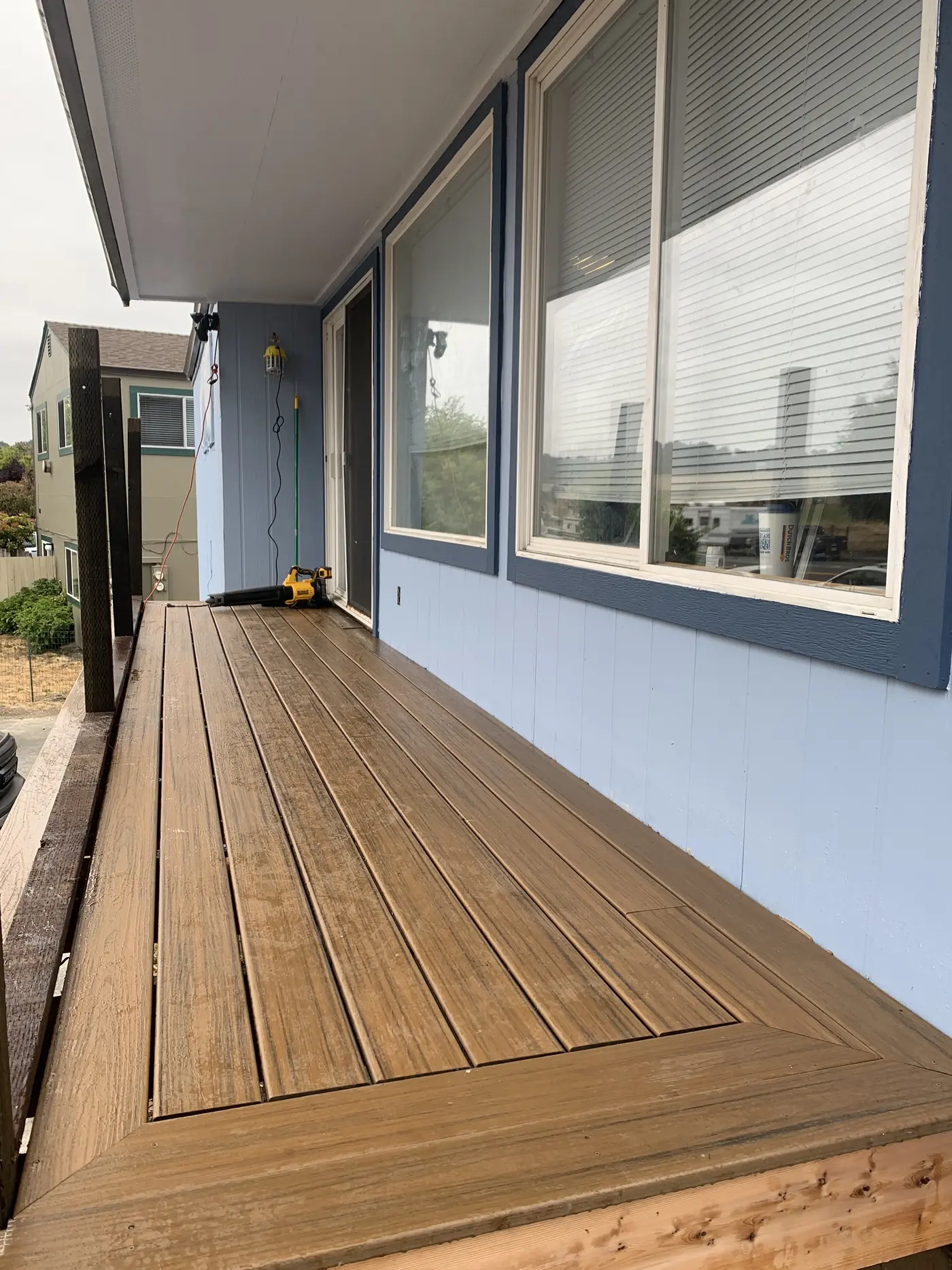 Finished Trex Havana Gold decking with a picture-frame border, running the length of the unit