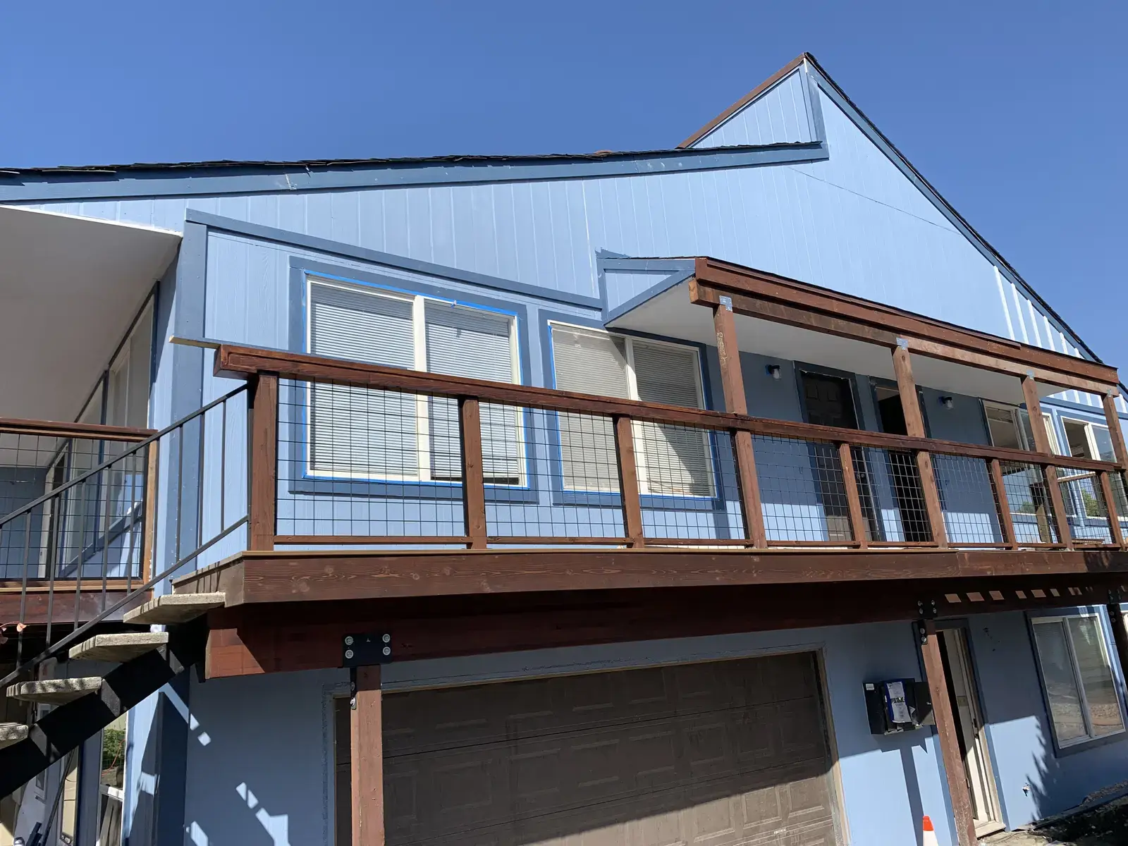 Second-floor balcony with cedar railing, welded wire infill and Trex decking