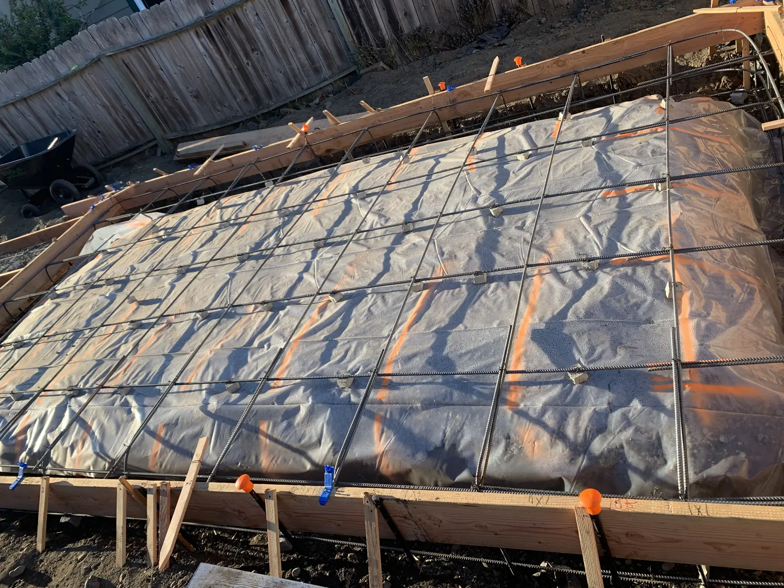 Formed foundation for the new detached garage with vapor barrier and rebar mat set, ready for the pour