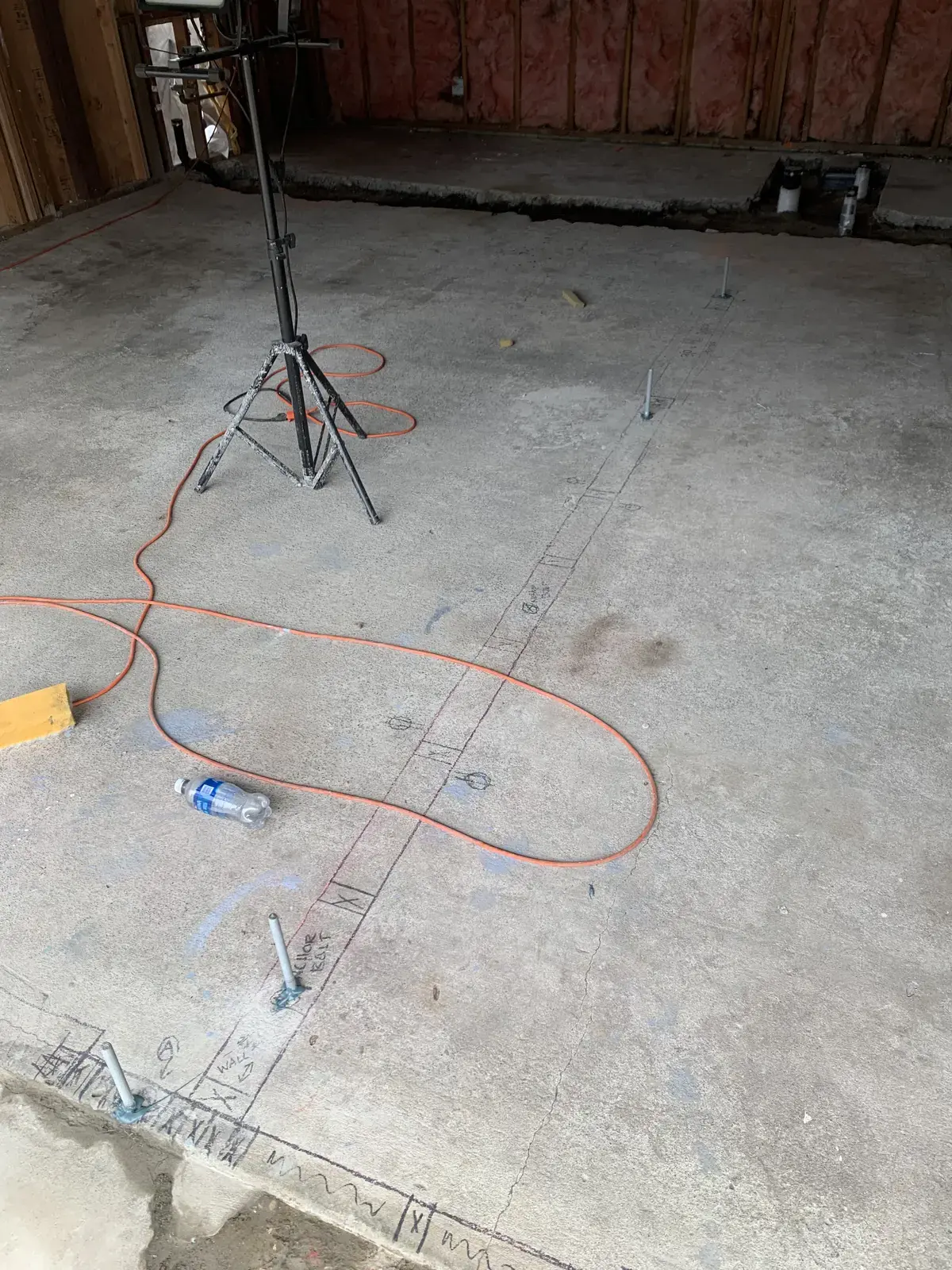 The bare garage slab with layout lines snapped for the new interior walls