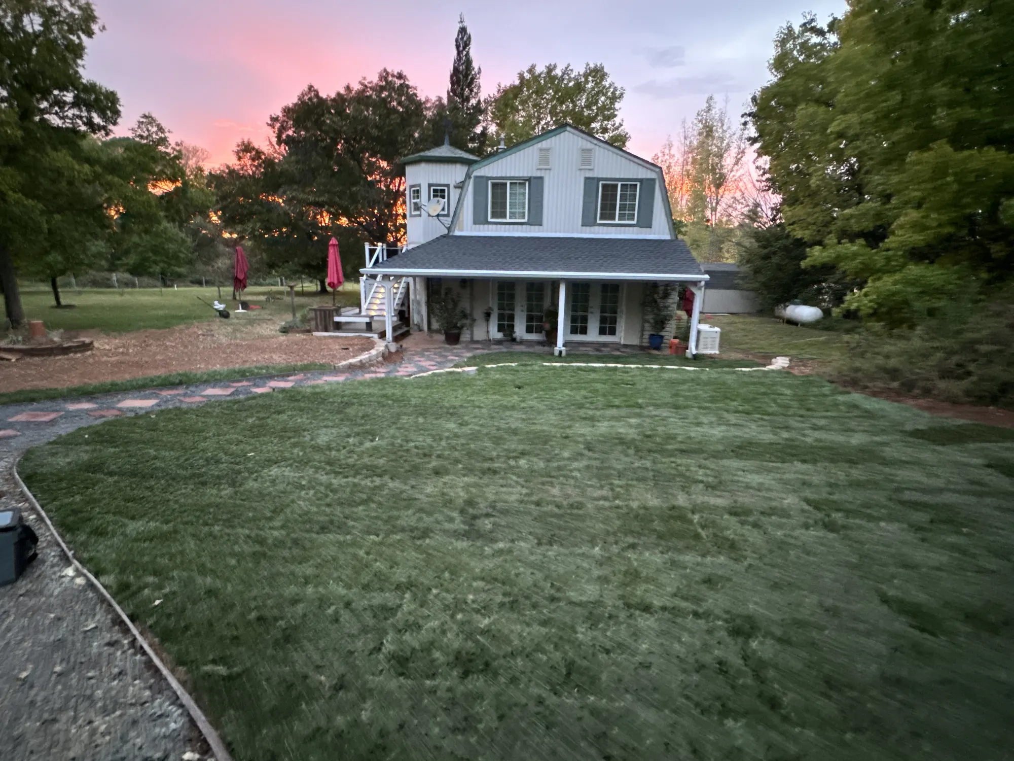 Completed barn-style residence with a new porch and fresh sod at a Marysville investment property