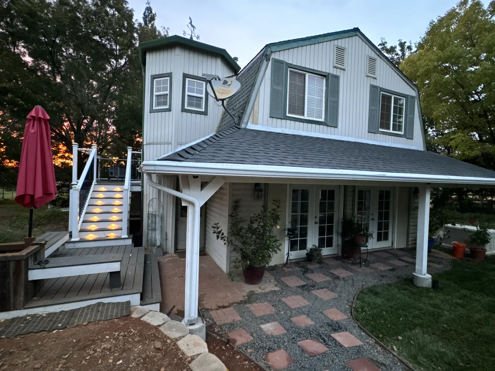 The finished Loma Rica house at sunset with its new covered porch, paver walkway and new lawn