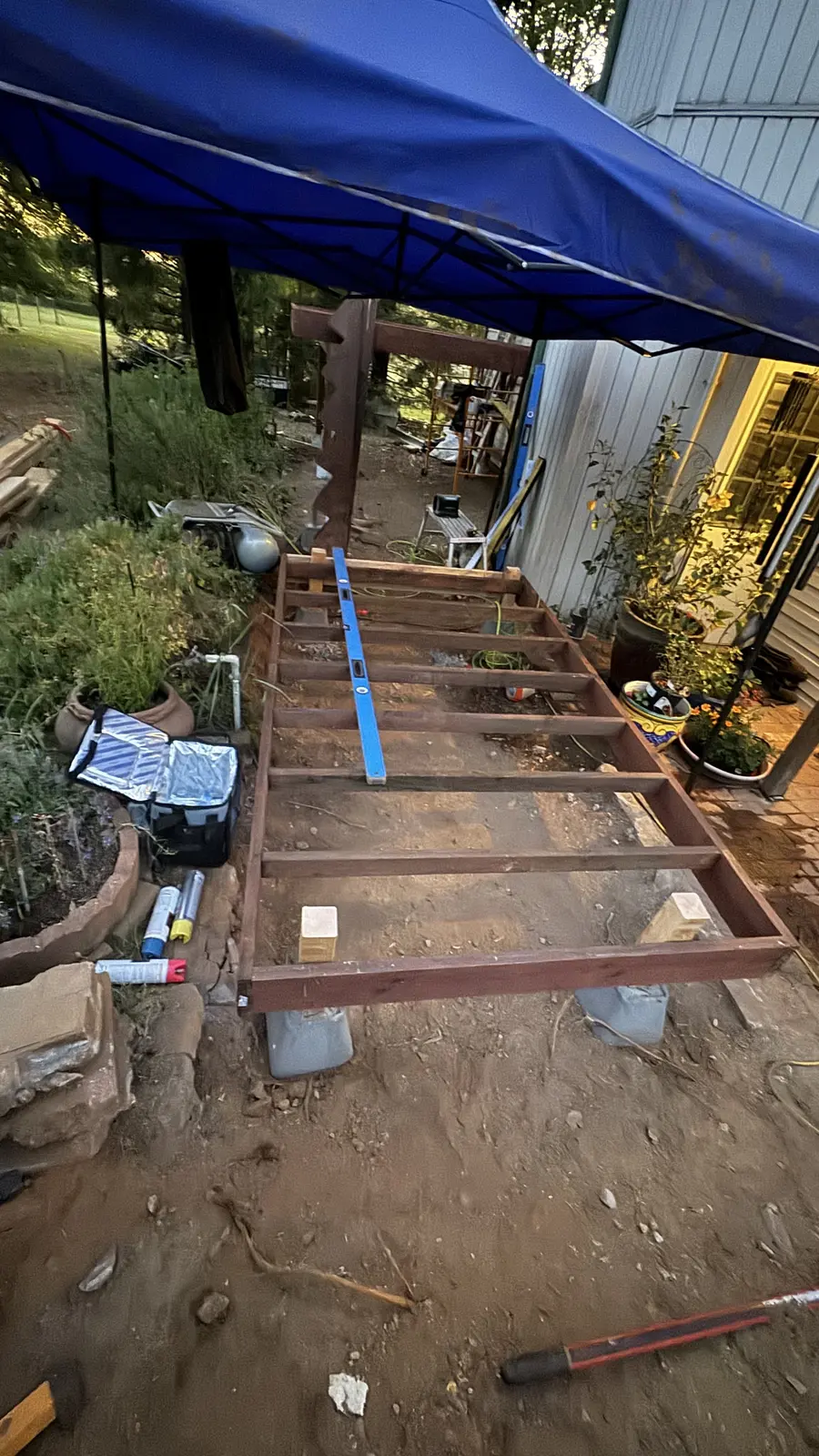 New deck framing, beams and joists set over the regraded ground