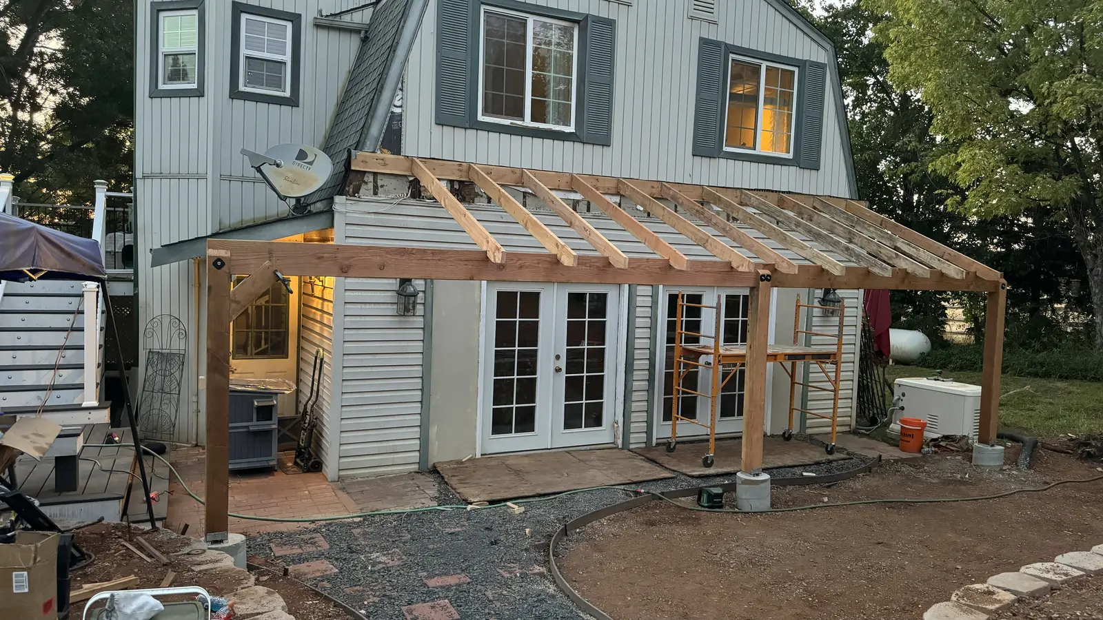 Rafters framed across the full width of the house for the new covered porch