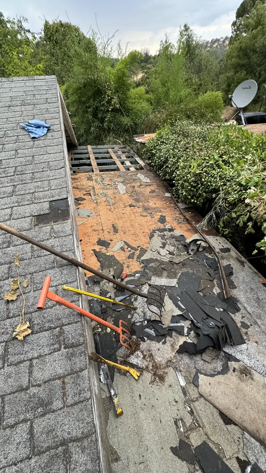 Shingle tear-off underway across the roof