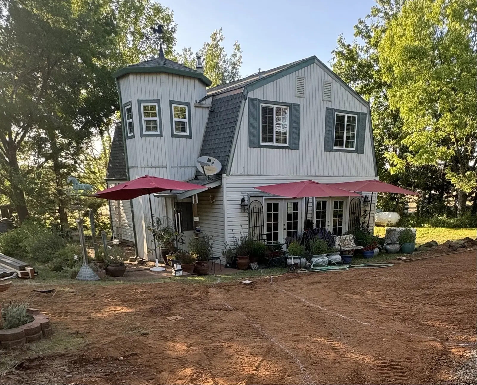 The house with the entire yard stripped back to bare graded dirt