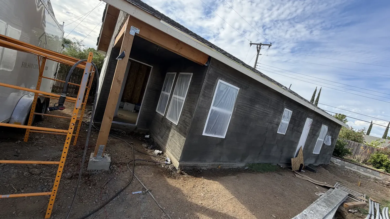 747 square foot detached ADU in Sacramento with stucco brown coat applied and windows masked for the finish coat