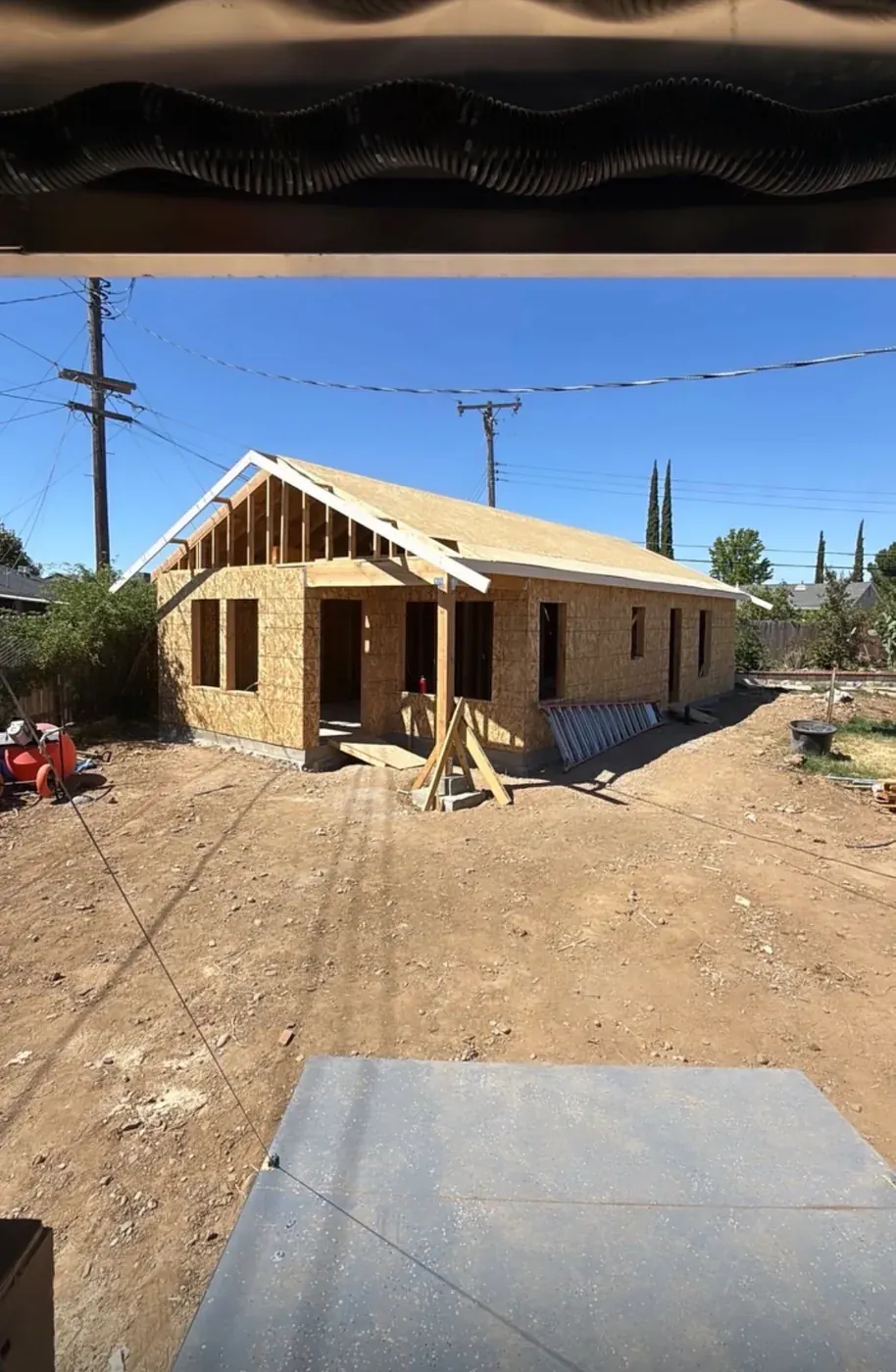 ADU shell fully sheathed with the covered porch framed at the entry